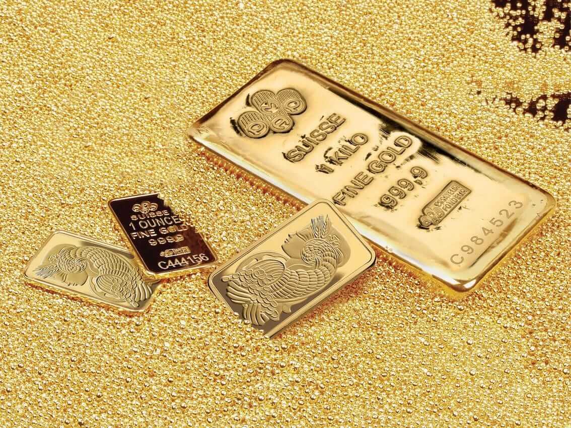 minted bars and gold cast bars laying in a pool of gold pellets